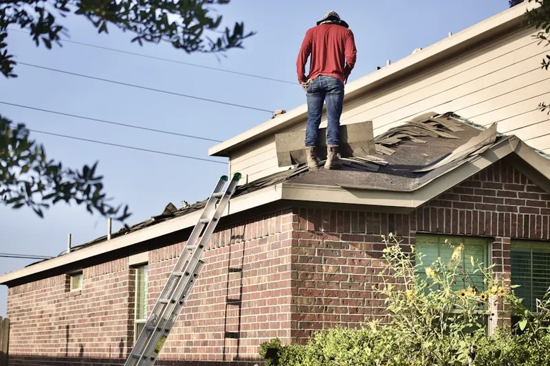Professional roofer working on a residential roof in Harbor View